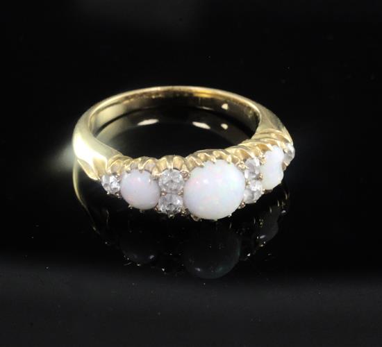 An early 20th century gold, white opal and diamond half hoop ring, size K.